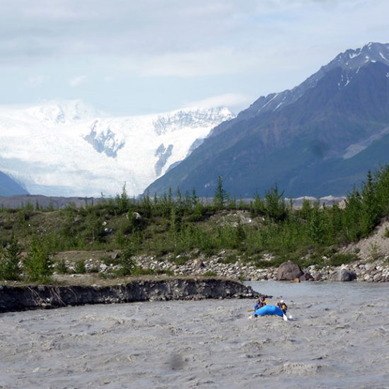 Rafters rafting in Alaska with glacier behind them - Explore McCarthy